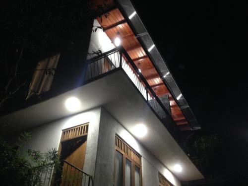 a house with a staircase on top of it at night at Witherspoon Lodge in Kandy