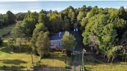an aerial view of a house in the woods at Cabañas Costa Aituy in Queilén