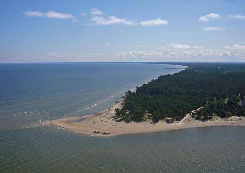 an aerial view of an island in the ocean at Zīriņi in Kolka