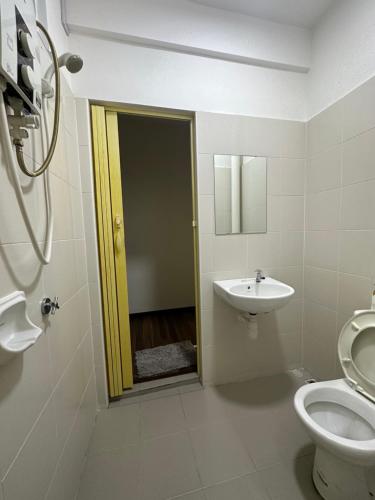 a bathroom with a toilet and a sink at TuR15 SPlCE 10pax 4room Private House in Bayan Lepas