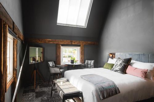 a bedroom with a large bed and a window at Stillwater Seven in Launceston