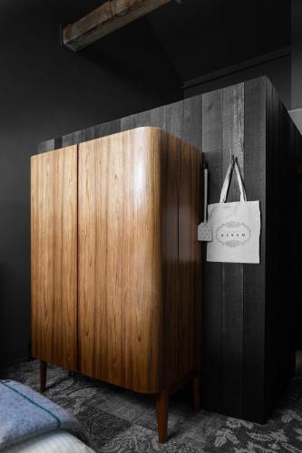 a wooden cabinet with a bag hanging on a wall at Stillwater Seven in Launceston