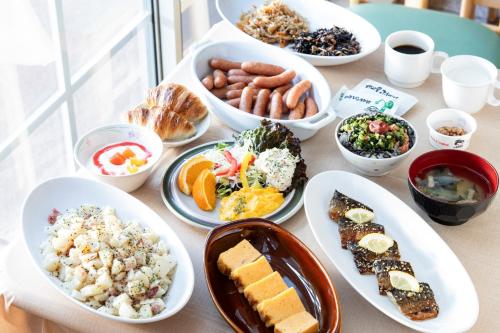 a table with many plates of food on it at Shirakabako Hotel Paipuno Kemuri in Chino