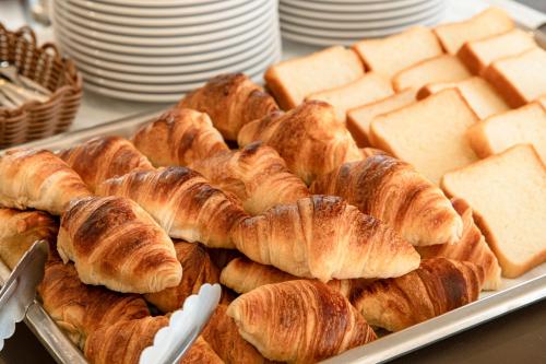 a tray of croissants and bread on a table at Shirakabako Hotel Paipuno Kemuri in Chino
