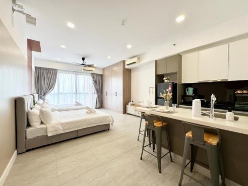 a large bedroom with a bed and a kitchen at Bell Suites @ Sepang by Moka in Sepang
