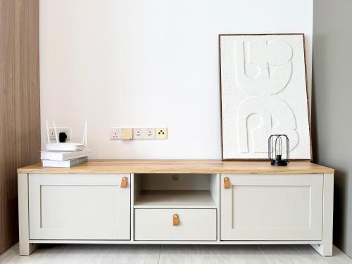 a white dresser with a mirror on top of it at Bell Suites @ Sepang by Moka in Sepang