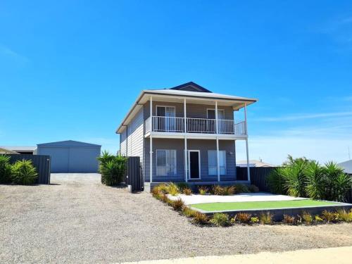 a house with a tennis court in front of it at Hamilton House in Port Hughes