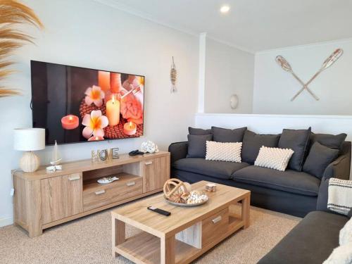 a living room with a couch and a tv at Hamilton House in Port Hughes