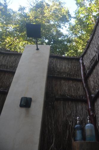 a television sitting on top of a table on a fence at Glamping Mayan Glam in Tulum