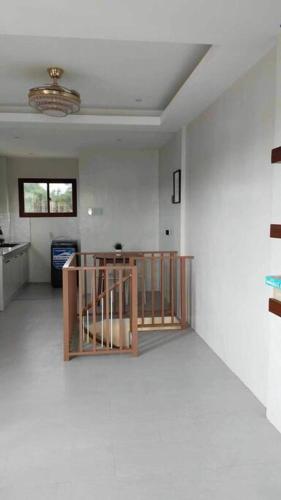 a room with a staircase in the middle of a room at Staycation San Jose Del Monte City in Santo Cristo