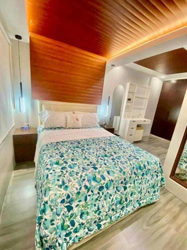 a bedroom with a large bed and a wooden ceiling at Staycation San Jose Del Monte City in Santo Cristo