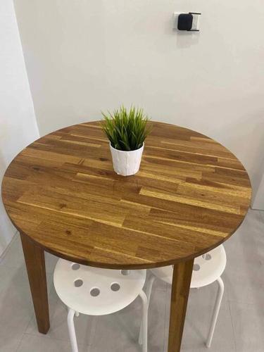 a wooden table with a potted plant on top of it at Staycation San Jose Del Monte City in Santo Cristo