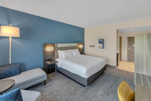 a hotel room with a bed and a couch at Holiday Inn Express & Suites Fort Walton Beach - Eglin Area by IHG in Fort Walton Beach
