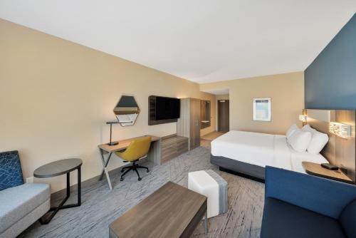 a hotel room with a large bed and a desk at Holiday Inn Express & Suites Fort Walton Beach - Eglin Area by IHG in Fort Walton Beach