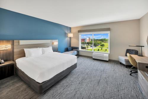 a hotel room with a bed and a window at Holiday Inn Express & Suites Fort Walton Beach - Eglin Area by IHG in Fort Walton Beach