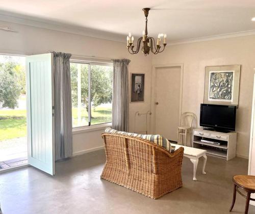 a living room with a couch and a tv at Pine Lodge in Pine Point