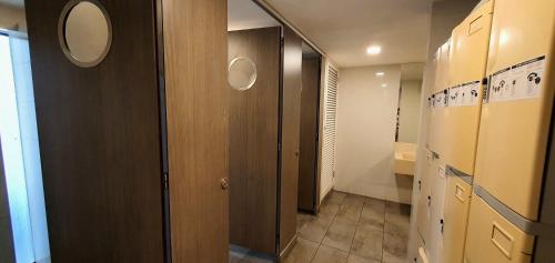 a hallway of a bathroom with a door and a sink at MCity Jalan Ampang in Kuala Lumpur