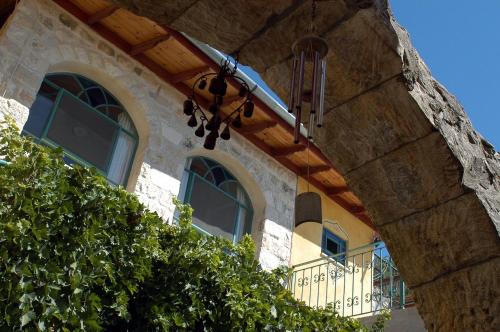 a building with two windows and a balcony at The Way Inn - Boutique Suites in Safed