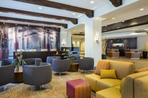 a lobby with couches and chairs in a hotel at Courtyard by Marriott Anaheim Theme Park Entrance in Anaheim