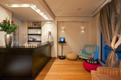 a hair salon with a reception desk and a chair at O&B Athens Boutique Hotel in Athens
