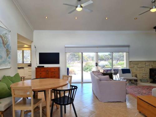 a living room with a table and a couch at Tidal Life in Wool Bay