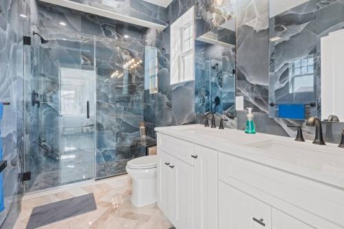 a bathroom with a sink and a toilet and a shower at Unlimited Ocean Views 5 BR 5 Bath Beach Block in Seaside Heights