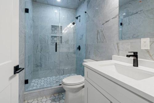 a bathroom with a shower and a toilet and a sink at Unlimited Ocean Views 5 BR 5 Bath Beach Block in Seaside Heights