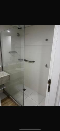 a glass shower stall in a bathroom with at Granja Brasil Flat Itaipava in Araras Petropolis