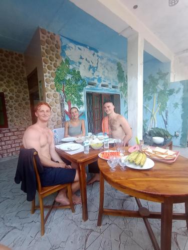 a group of people sitting around a table at The Golden Bow in Seeduwa
