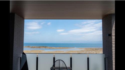 a view of the ocean from a balcony of a building at EZRA VILLA shirahama in Shirahama