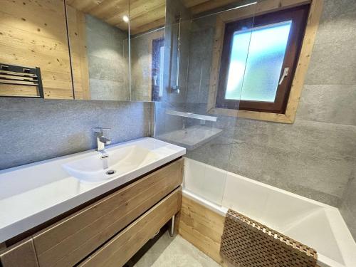 une salle de bain avec un lavabo et une baignoire dans l'établissement Appartement 2 pièces avec cabine, terrasse sud, proche télécabine Jaillet, parking, Wi-Fi - FR-1-597-184, à Megève