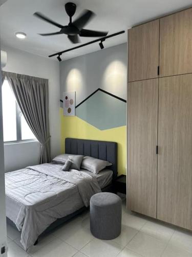 a bedroom with a bed and a ceiling fan at Bangi Avenue Condo in Kajang