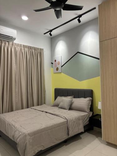 a bedroom with a bed and a ceiling fan at Bangi Avenue Condo in Kajang