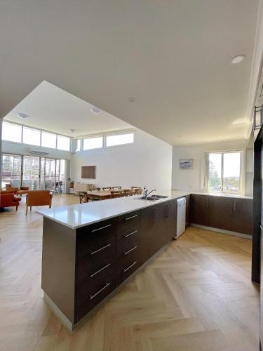 a large kitchen with a large island in a room at Capeview 12 in South West Rocks