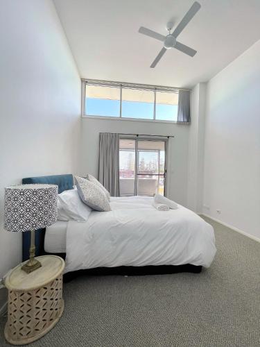 a bedroom with a large bed and a window at Capeview 12 in South West Rocks