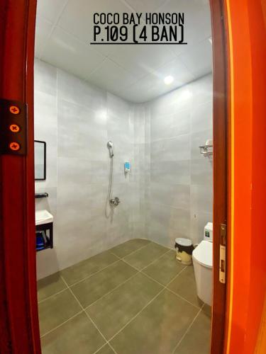 a bathroom with a shower and a toilet at Coco Bay Hon Son in Lai Sơn