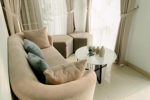 a living room with a couch and a table at Akhtar Guest House Near Situ Gede in Tasikmalaya