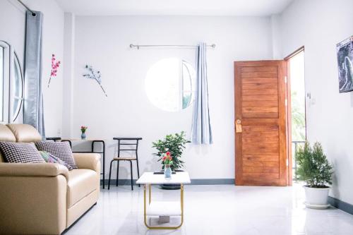 a living room with a couch and a wooden door at Relax home in Ao Nang 