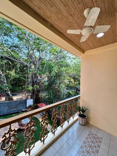 a balcony with a ceiling fan and a view of trees at 360 Bliss Dia Hotels in Nerul
