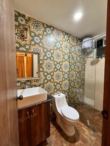 a bathroom with a toilet and a sink at 360 Bliss Dia Hotels in Nerul