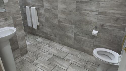 a bathroom with a toilet and a sink at Midrand Conference Centre in Midrand