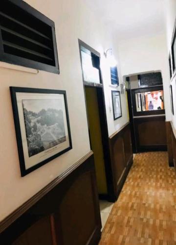 a room with a hallway with a door and a wooden floor at Hotel mystique inn in Ooty