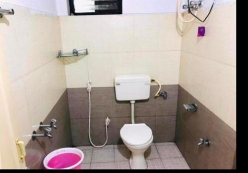 a bathroom with a toilet and a shower at Hotel mystique inn in Ooty
