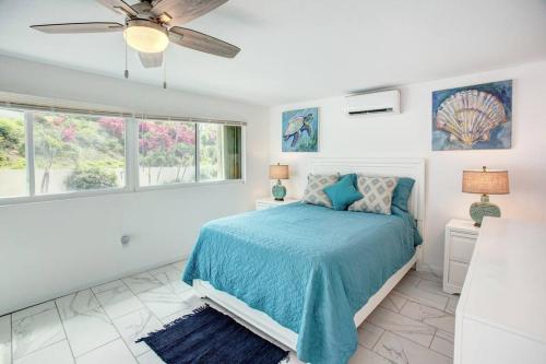a bedroom with a bed and a ceiling fan at Beautiful Ocean Views Amazing Sunsets three pool! in Nazareth