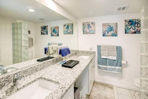 a white bathroom with a sink and a counter top at Beautiful Ocean Views Amazing Sunsets three pool! in Nazareth