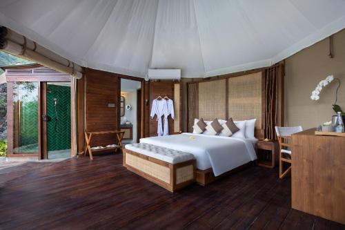 a bedroom with a large white bed in a tent at The Wapa Lux Tent in Sidemen