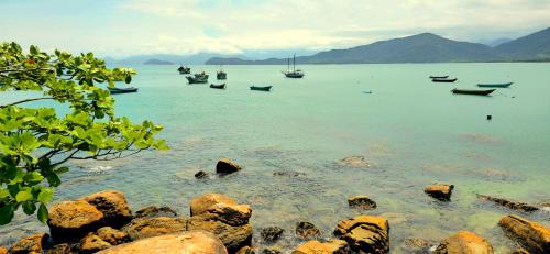 a group of boats in a large body of water at Pousada Sobre As Ondas de Picinguaba in Picinguaba