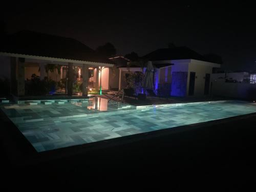 a swimming pool lit up at night at LAM BUNGALOW Resort & Spa in Phu Quoc