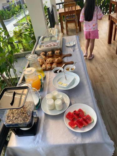 a little girl standing in front of a table with food at LAM BUNGALOW Resort & Spa in Phu Quoc