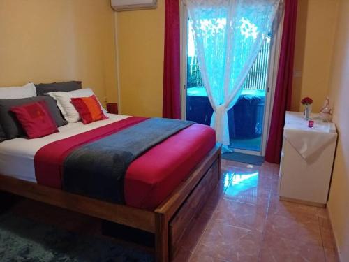 a bedroom with a large bed and a window at Le chapeau de Paille in Saint-Louis